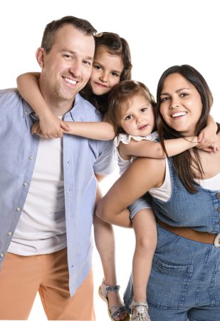 A family with his two daughter girl on studio white background